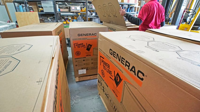 A worker inspects a 24-kilowatt Generac home generator at Captain Electric in Orem, Utah, on Feb. 18, 2021.