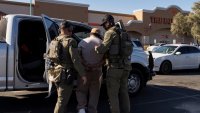 One of two documented immigrants with prior convictions detained by U.S. Immigrations and Customs (ICE) Homeland Security Investigations (HSI) agents, walks towards a vehicle, at a Home Depot parking lot in Tucson, Arizona, U.S., January 26, 2025. 
