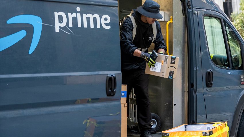 A worker unloads boxes from an Amazon delivery van in San Francisco on Oct. 24, 2024.