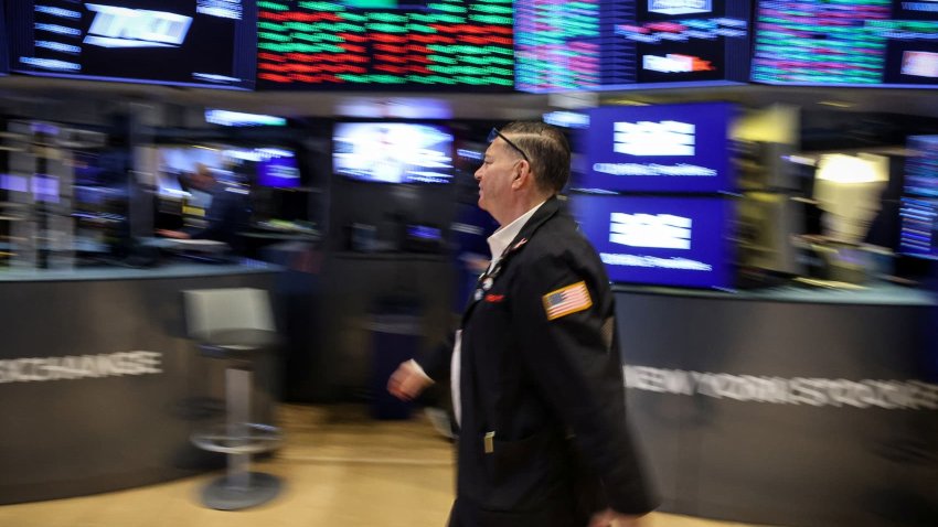 Traders work on the floor at the New York Stock Exchange (NYSE) in New York City, U.S., March 19, 2025. 