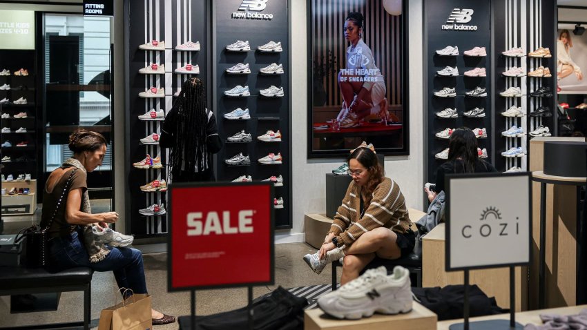 Shoppers try on shoes at a Footlocker store in New York City, U.S., May 16, 2025.