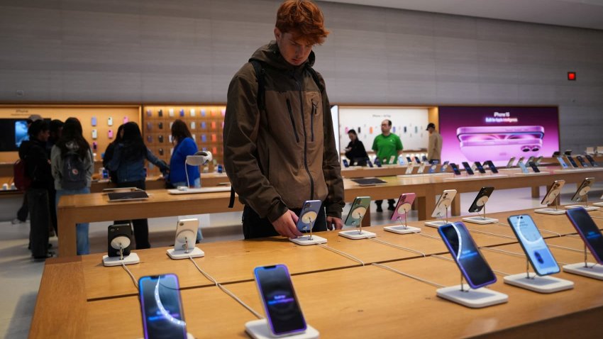 A person looks at iPhones in the Apple Fifth Avenue store in New York City, U.S., May 23, 2025.