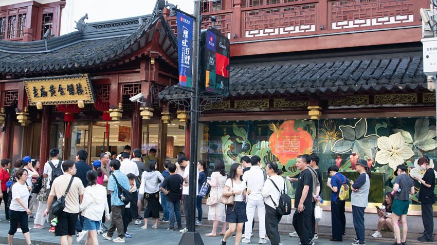 Huge waiting lines are seen in front of jewelry retailer stores at Yu Garden in Shanghai, China, on May 17, 2025, as the city offers consumption vouchers to stimulate consumer spending.