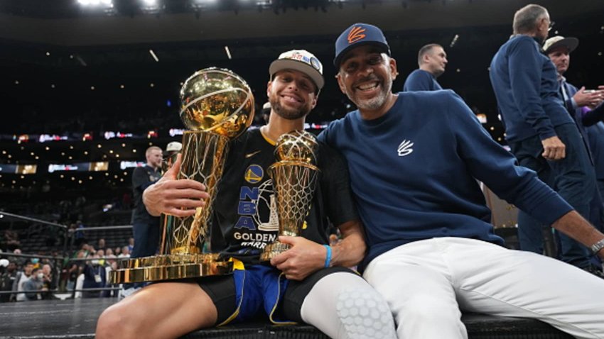 Stephen Curry, #30 of the Golden State Warriors celebrates with his dad, Dell Curry, after winning Game 6 of the 2022 NBA Finals at TD Garden in Boston, Massachusetts.
