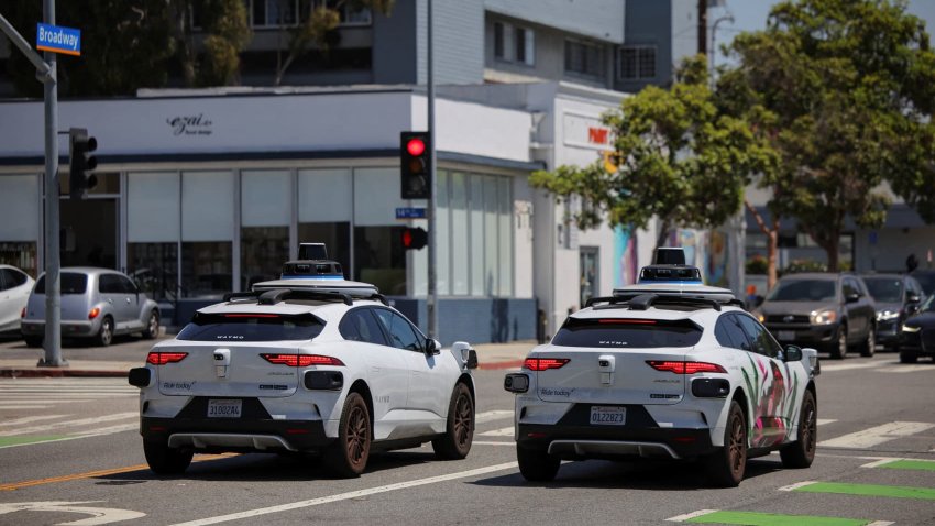 Waymo driverless vehicles wait at a traffic light in Santa Monica, California, U.S., May 30, 2025.