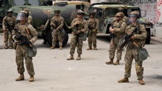 California National Guard personnel stand outside the Edward R. Roybal federal building after their deployment by U.S. President Donald Trump, in response to protests against immigration sweeps, in Los Angeles, California, U.S. June 8, 2025.