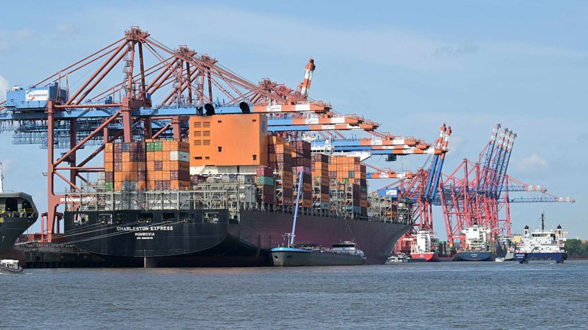 Cargo shipping containers are loaded with cranes on container ships at the Burchardkai container terminal at the harbour of Hamburg, northern Germany, on June 3, 2025.
