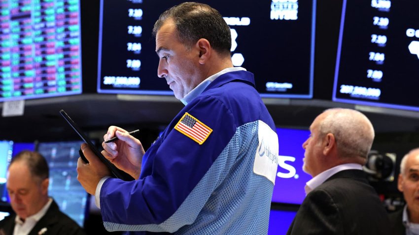 Traders work on the floor at the New York Stock Exchange on June 11, 2025.