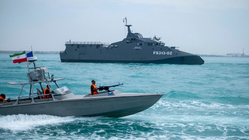 The IRGC Navy Martyr Hassan Bagheri warship and an IRGC speed boat are sailing along the Persian Gulf during the IRGC marine parade, which is commemorating the Persian Gulf National Day, near the Bushehr nuclear power plant in the seaport city of Bushehr, Bushehr province, in the south of Iran, on April 29, 2024.