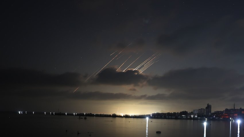 Trails of Iranian ballistic missiles light up the night sky as seen from Gaza City during renewed missile strikes launched by Iran in retaliation against Israel on June 15, 2025.