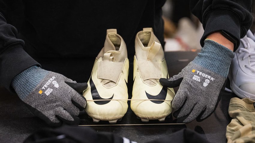 A worker sorts incoming clothing items at Artikel2’s sorting center in Stockholm on April 10, 2025.