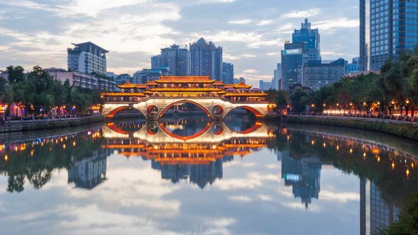 Anshun bridge reflecting in the Jinjiang river at dusk in Chengdu, Sichuan Province, China.