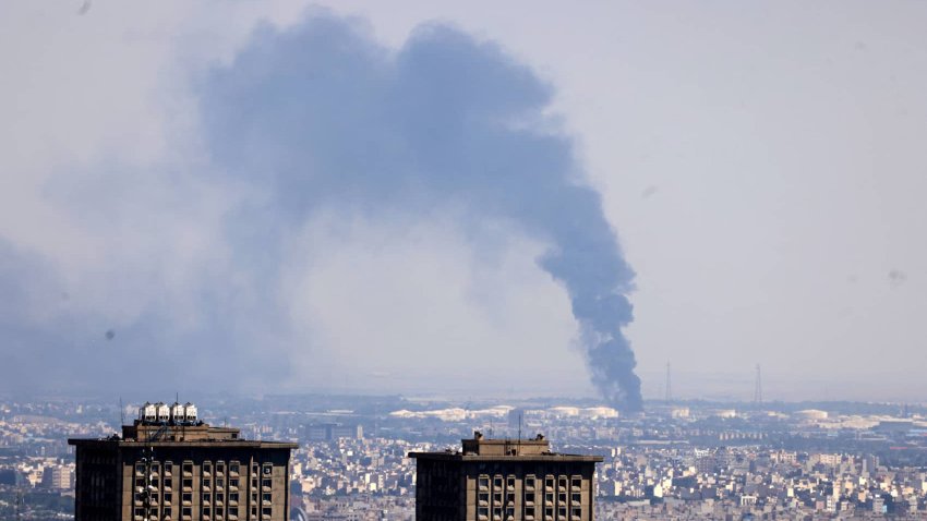 Smoke billows in the distance from an oil refinery following an Israeli strike on the Iranian capital Tehran on June 17, 2025.