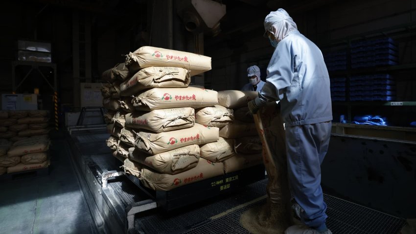 A worker handles sacks of brown rice at a Shinmei Co. plant in Kawaguchi, Saitama Prefecture, Japan, on Tuesday, Sept. 24, 2024. Bags of rice are expected to start filling the shelves of Japan’s supermarkets again soon as farmers harvest their new crop, though the increase in supply will do little to tame higher prices. Photographer: Kiyoshi Ota/Bloomberg via Getty Images