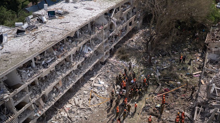 Emergency responders gather outside a damaged building at the site of an Iranian airstrike on June 22, 2025 in the Ramat Aviv neighborhood Tel Aviv, Israel.