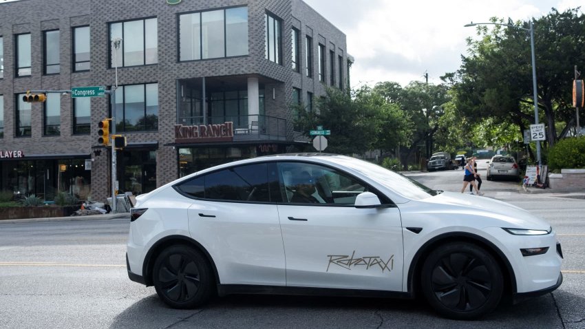 A Tesla robotaxi drives on the street along South Congress Avenue in Austin, Texas, on June 22, 2025