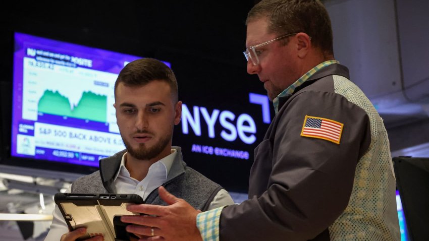 Traders work on the floor at the New York Stock Exchange (NYSE) in New York City, U.S., June 23, 2025.