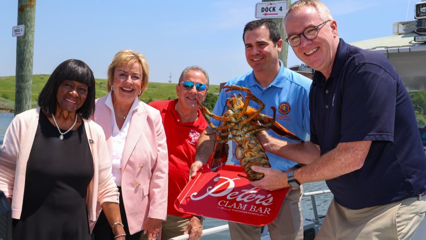 Photo of group holding Lorenzo, the 110-year-old lobster.