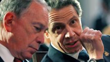 FILE - This March 16, 2012 file photo shows then New York Mayor Michael Bloomberg, left, and New York Gov. Andrew Cuomo at a bill signing ceremony in the Red Room at the Capitol, in Albany, N.Y.  Bloomberg will help create a "tracing army" that will help find people infected with the coronavirus and get them into isolation, Cuomo announced Wednesday, April 22, 2020. (AP Photo/Mike Groll, File)