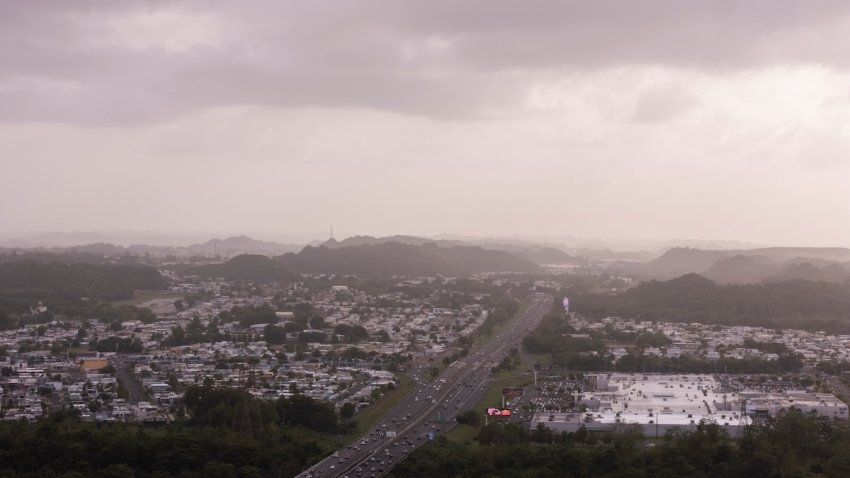 Cars drive along a highway as a cloud of dust from the Sahara Desert blankets most of the Caribbean, in Cataño, Puerto Rico, Monday, June 2, 2025.