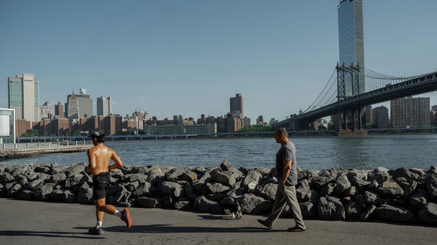 People exercise on the Brooklyn waterfront during a heat wave on Tuesday, June 24, 2025, in New York.
