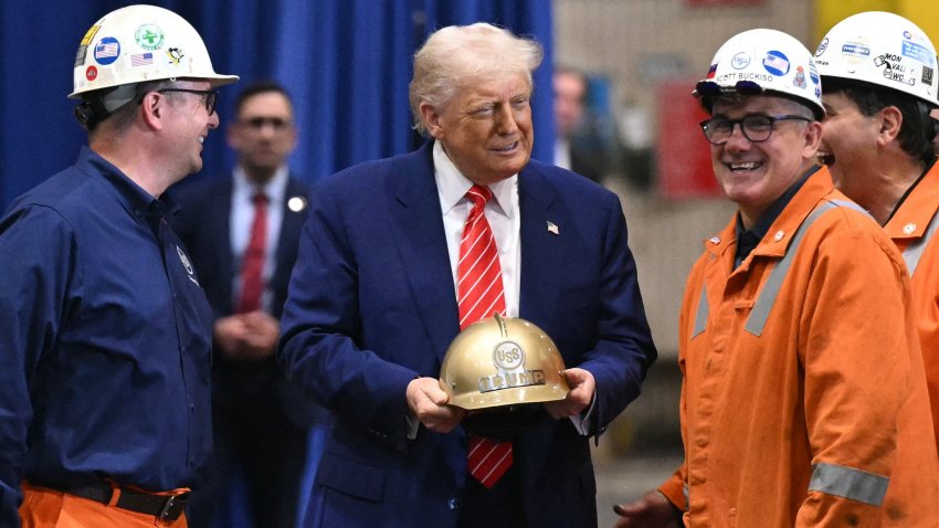 President Donald Trump receives a gold helmet with his name on it during a visit to US Steel - Irvin Works in West Mifflin, Pennsylvania.