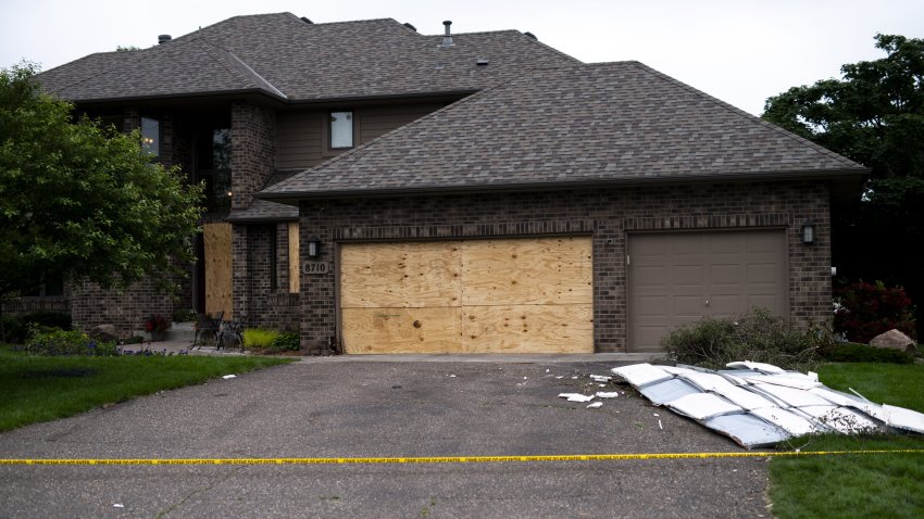 Boards cover the doors and windows outside the home of DFL State Rep. Melissa Hortman on June 15, 2025 in Brooklyn Park, Minnesota.