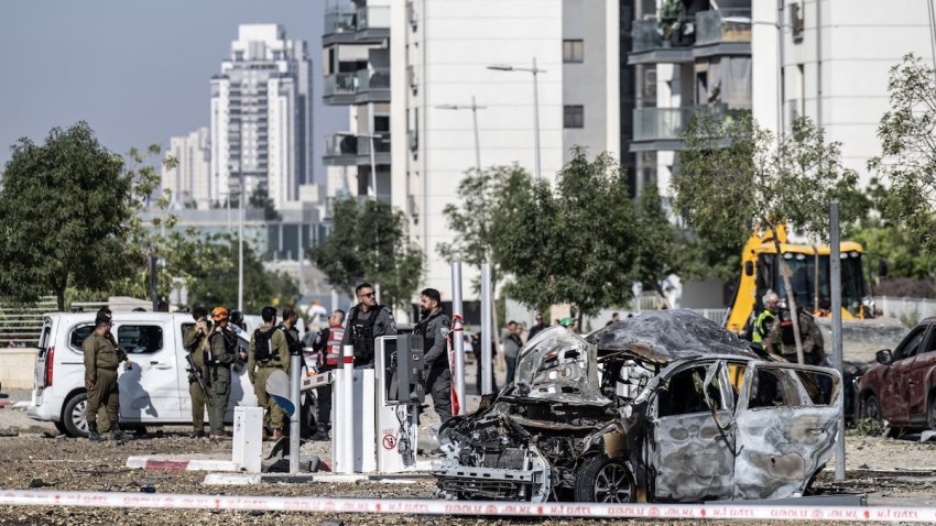 Israeli police officers and bomb disposal experts are seen working at the impact site after a missile reportedly launched from Iran struck the southern Israeli city of Beersheba on June 20, 2025. Authorities began investigations following the incident as part of broader security measures amid ongoing regional tensions.