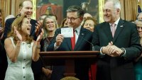 U.S. Speaker of the House Mike Johnson (R-LA) holds up the vote total as he delivers remarks alongside fellow House Republicans during an enrollment ceremony for H.R. 1, the One, Big, Beautiful Bill Act at the U.S. Capitol on July 03, 2025 in Washington, DC.