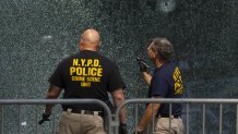 Members of NYPD Crime Unit examine a door with bullet holes at the scene of Monday's deadly shooting, Tuesday, July 29, 2025, in New York. (AP Photo/Yuki Iwamura)