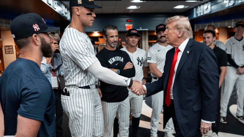 President Donald Trump shakes hands with New York Yankees Aaron Judge in the New York Yankees locker room before a baseball game against the Detroit Tigers, Thursday, Sept. 11, 2025, in New York.