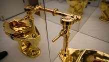 'America,' the toilet cast from more than 100 kilograms of solid 18-karat gold, by Maurizio Cattelan is displayed during a press preview at Sotheby's on November 07, 2025 in New York City. The estimated value, will be set according to the work’s literal weight in gold on the day of auction. Tomorrow, Sotheby’s opens its new global headquarters on Madison Avenue in the Marcel Breuer building. The space will be free and open to the public until auction previews conclude. Upcoming sales include The Leonard A. Lauder Collection, The Cindy and Jay Pritzker Collection, The Now and Contemporary Auction, The Exquisite Corpus Auction, and the Modern Day Auction, scheduled for November 18–21, 2025. 