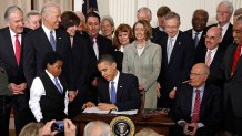 President Barack Obama signs the Affordable Health Care for America Act during a ceremony with fellow Democrats in the East Room of the White House on March 23, 2010 in Washington, DC. 