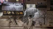 A person cleans the street as snow falls during a winter storm in New York City, U.S., December 26, 2025. (Photo by Mostafa Bassim/Anadolu via Getty Images)