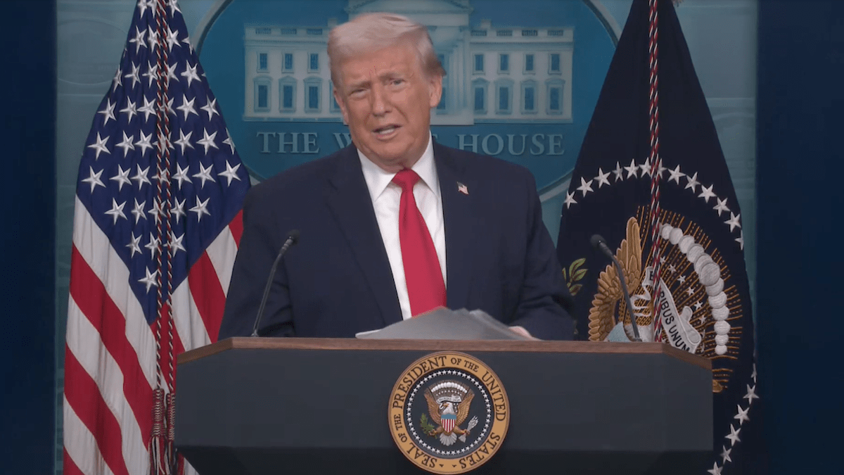 Trump took to the podium holding a book of what he said are his administration's accomplishments over his first 365 days in office.