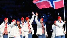 Norway's flag bearer Peder Kongshaug (R) and (From L) Norway's Henrik Fagerli Rukke, Norway's Julie Nistad Samsonsen, Norway's Didrik Eng Strand parade during the opening ceremony of the Milano Cortina 2026 Winter Olympic Games at the San Siro stadium in Milan, northern Italy, on February 6, 2026.