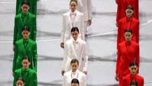 Models wearing creations designed by Giorgio Armani walk during the opening ceremony