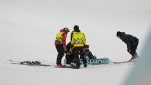 Feb 12, 2026; Livigno, Italy; Gaon Choi of the Republic of Korea is tended to by staff after falling on her first run in the women's halfpipe final during the Milano Cortina 2026 Olympic Winter Games at Livigno Snow Park. Mandatory Credit: Joe Camporeale-Imagn Images