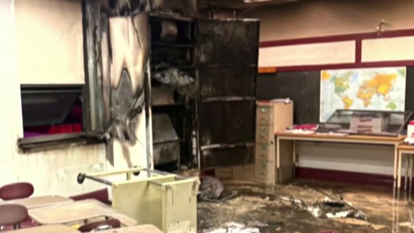 Charred walls and damaged items from a fire inside a school classroom
