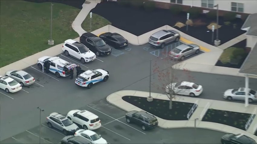 Police gather in the parking lot of a nursing home in Egg Harbor Township, New Jersey, on Monday morning after, officials said, two people there were shot.