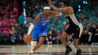Oklahoma City Thunder guard Shai Gilgeous-Alexander (2) works toward the basket as San Antonio Spurs guard De’aaron Fox (4) defends during the second half of Game 3 in the Western Conference finals NBA basketball playoffs series Friday, May 22, 2026, in San Antonio.