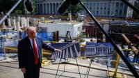 President Donald Trump speaks to members of the media near the ballroom construction site at the White House.
