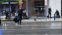 Members of the U.S. Secret Service tend to a wounded man on the scene of a shooting near the White House on May 23, 2026 in Washington, DC.