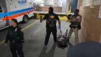 ICE officers guard a detainee who was on the ground during a clash with a crowd outside Wyckoff Heights Medical Center Saturday