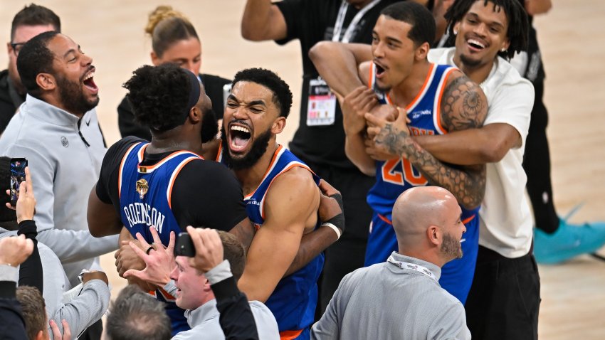 New York Knicks center Karl-Anthony Towns, right, hugs forward Og Anunoby during the after defeating the San Antonio Spurs in Game 5 of the NBA Finals basketball series, Saturday, June 13, 2026, in San Antonio.