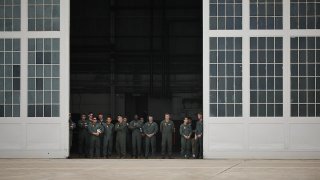 Airmen watch as President Donald Trump and first lady Melania Trump arrive at Lackland Air Force Base before heading off to Kerrville, Texas where they plan to visit with state and local leaders, first responders and victims of flash flooding on July 11, 2025 in San Antonio, Texas.