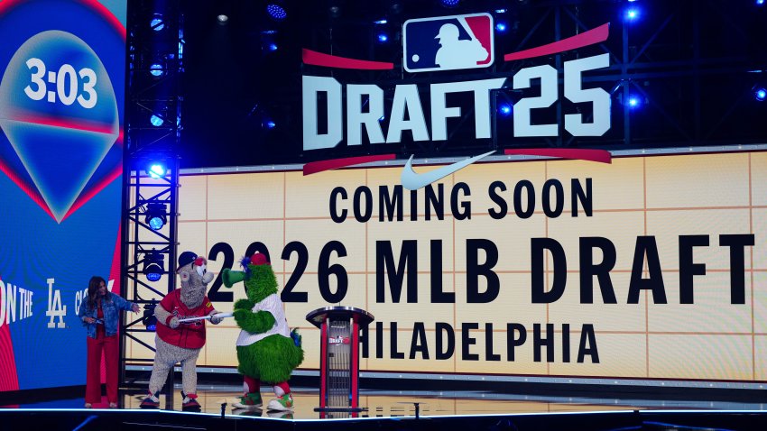 Atlanta Braves mascot Blooper and Philadelphia Phillies mascot Phillie Phanatic interact during the 2025 MLB Draft