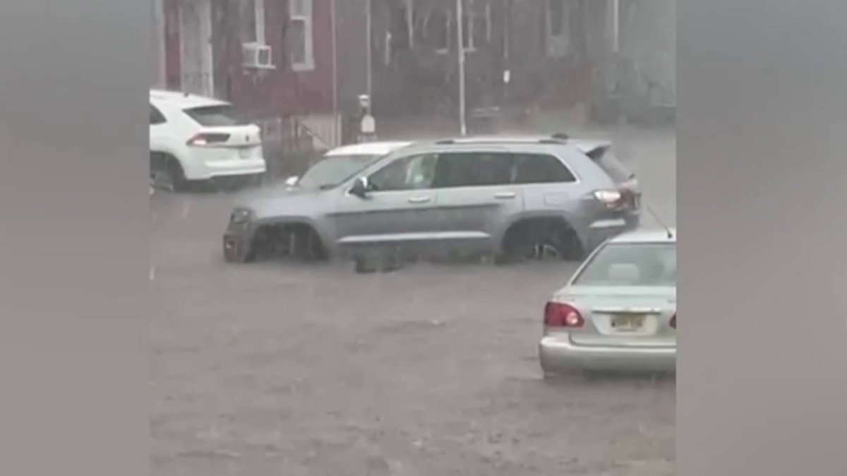 Families cleaning up after flooding in New Jersey left cars damaged from water