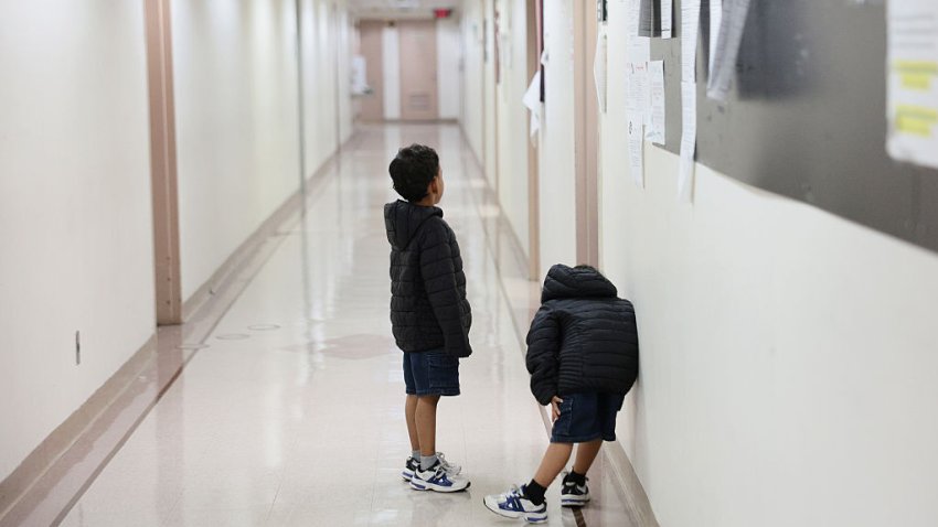 Children wait outside of an immigration court at the Jacob K. Javits Federal Building on July 31, 2026 in New York City.