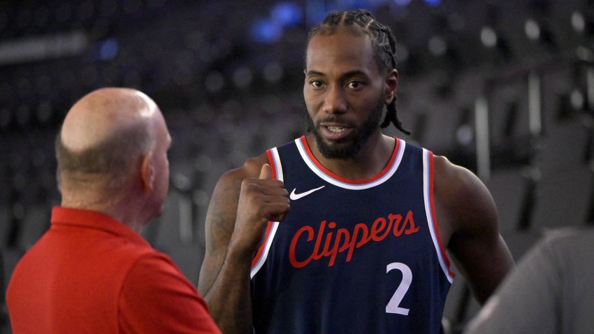 Clippers forward Kawhi Leonard (2) talks with team owner Steve Ballmer.